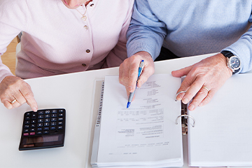 Home care couple doing paperwork - 360x240